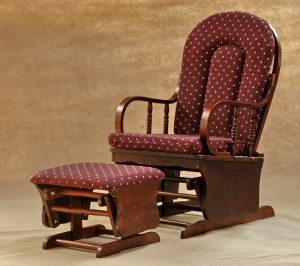 High back nursery glider chair with beige cushions and matching ottoman