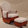 Swivel glider chair with padded high back, wooden frame and matching ottoman