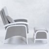 Side view of nursery glider chair with ottoman and curved armrests