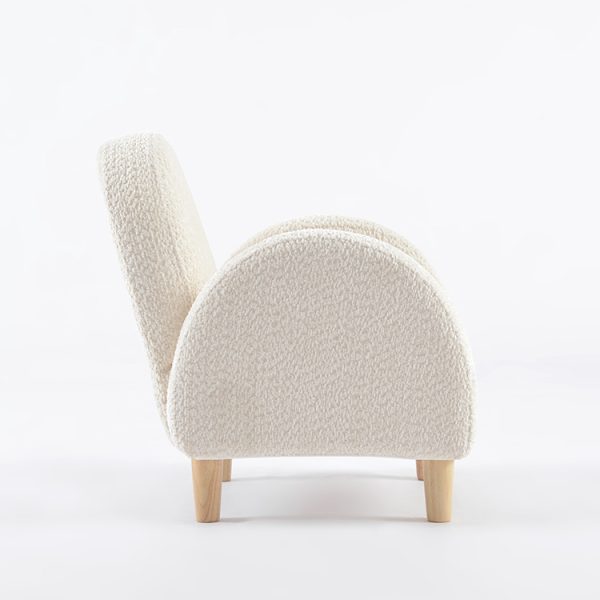 Cream Kids Armchair – Side View Side view of cream kids armchair showing rounded upholstered armrest and wooden legs