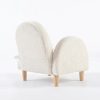 Upholstered Kids Armchair – Rear View Rear view of upholstered kids armchair with rounded back and cream textured fabric