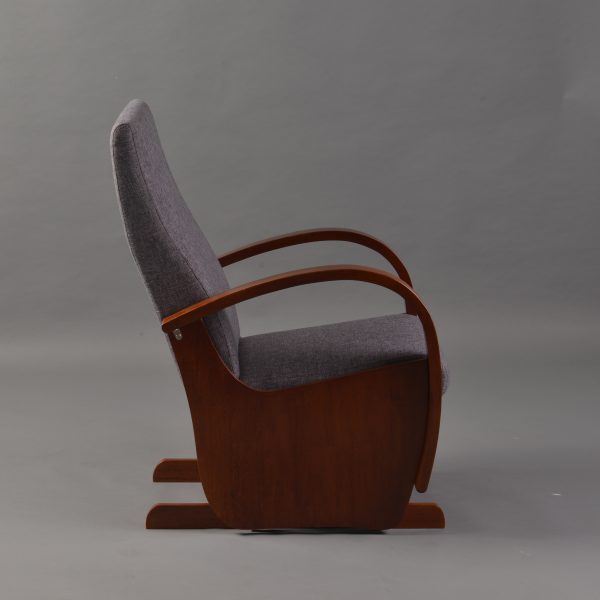 Side view of wooden nursery glider chair with high upholstered back