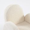 Textured Upholstery Detail of Kids Chair Close-up of soft textured cream upholstery and rounded armrest on kids chair