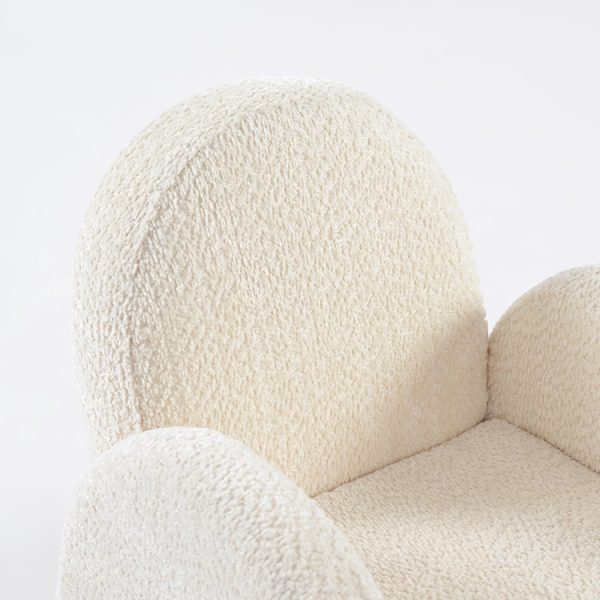Textured Upholstery Detail of Kids Chair Close-up of soft textured cream upholstery and rounded armrest on kids chair