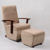 Beige high back nursery glider chair with dark wood armrests and ottoman