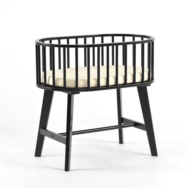 Baby bassinet with mattress featuring black wooden rails and elevated stand