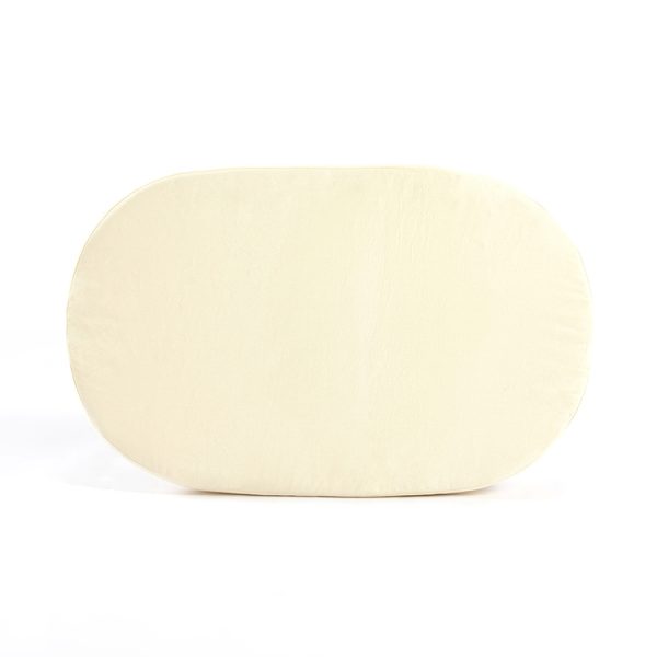 Cream oval mattress designed to fit the compact baby bassinet sleeping area
