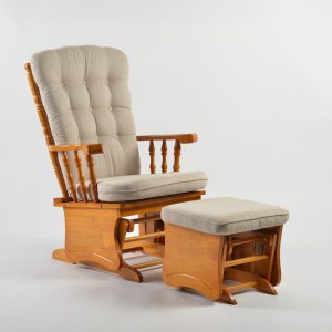 Button tufted nursery glider chair with cream upholstery and matching ottoman