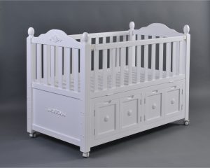 White Storage Baby Crib Side View Side view of large white baby crib with integrated storage