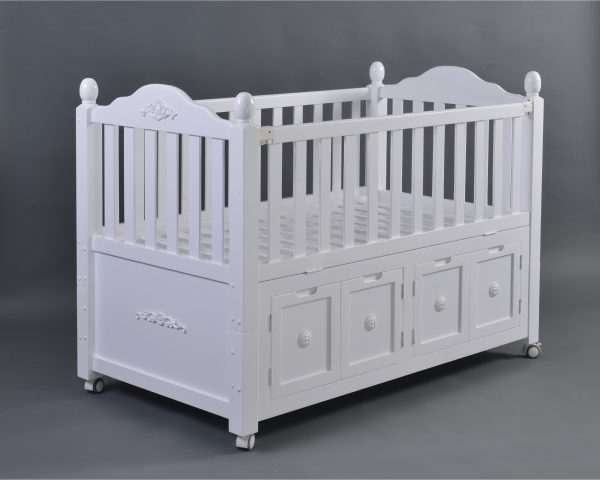 White Storage Baby Crib Side View Side view of large white baby crib with integrated storage