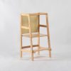 Back view of wooden toddler learning tower with chalkboard panel
