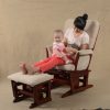 Mother sitting with baby in classic nursery glider chair with ottoman
