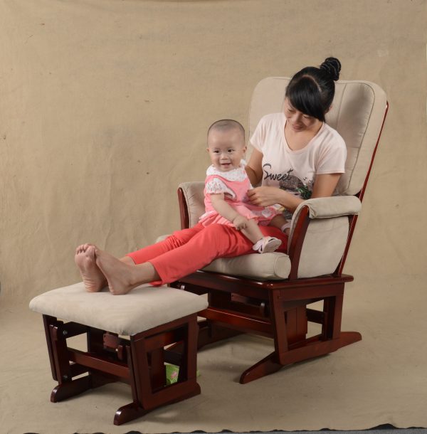 Mother sitting with baby in classic nursery glider chair with ottoman
