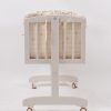 Side view of wooden baby rocking cradle with suspended cradle body