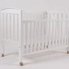 White wooden baby crib with lowered side panel and wheels