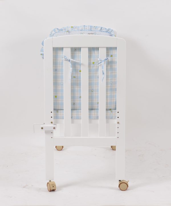 Wooden Bedside Baby Crib Side View Side view of white wooden bedside baby crib with caster wheels