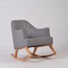 Gray upholstered nursery rocking chair with curved channel tufted back