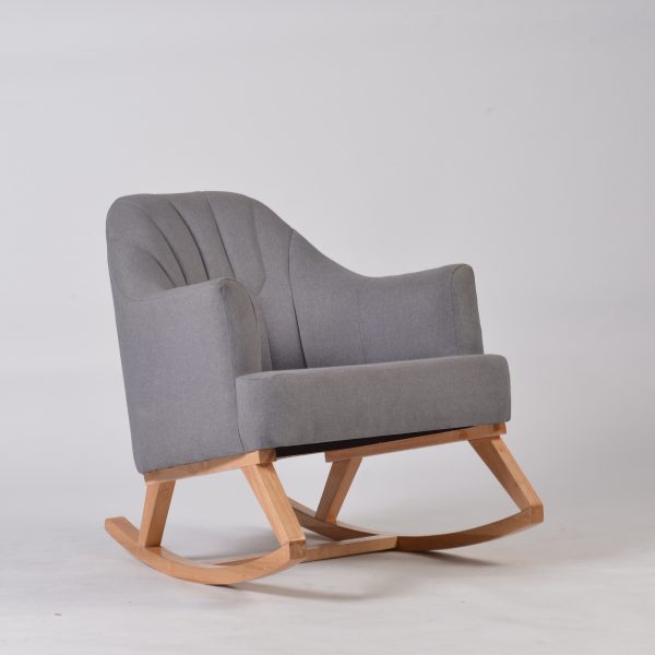 Gray upholstered nursery rocking chair with curved channel tufted back