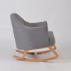 Side view of upholstered nursery rocking chair with natural wood rocker base