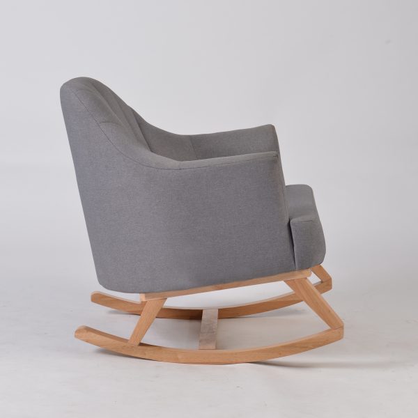 Side view of upholstered nursery rocking chair with natural wood rocker base