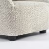 Close-up of textured bouclé kids sofa upholstery and soft animal-ear backrest
