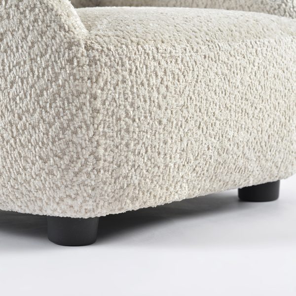 Close-up of textured bouclé kids sofa upholstery and soft animal-ear backrest