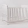 White Convertible Baby Crib Angled view of white convertible baby crib with slatted side panels