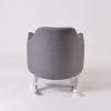 Rear side view of upholstered nursery rocking chair with white rocker base