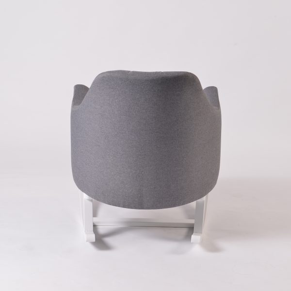 Rear side view of upholstered nursery rocking chair with white rocker base