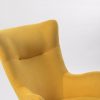 Close-up of mustard upholstered wingback rocking chair back