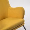 Close-up of mustard upholstered wingback rocking chair back