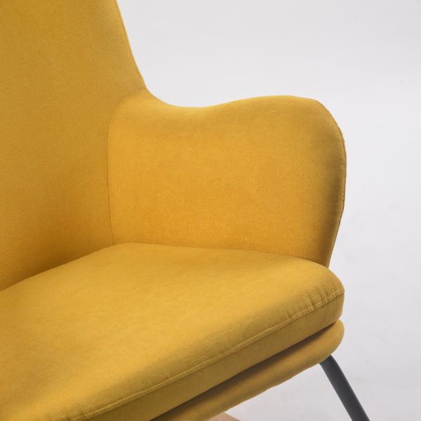 Close-up of mustard upholstered wingback rocking chair back