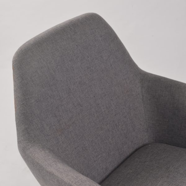 Gray fabric nursery rocker with black metal frame and wooden rails Side view of upholstered nursery rocking chair with curved wooden rails