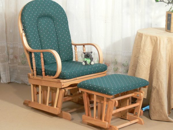 Natural Wood Nursery Glider Chair Natural wooden nursery glider chair with light green cushions and matching ottoman