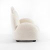 Cream upholstered kids armchair with curved padded sides and animal-ear details
