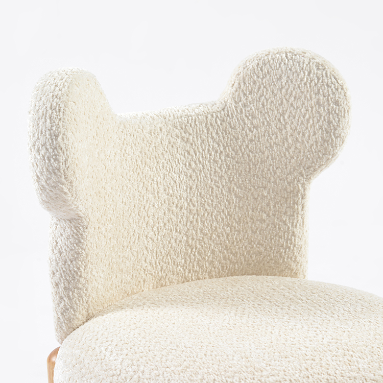 Close-up of soft bouclé mouse-ear backrest on upholstered kids chair