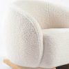 Close-up of natural wooden rocker base on cream upholstered kids rocking chair
