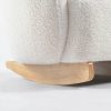 Close-up of soft cream bouclé upholstery on rounded kids rocking chair