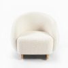 Cream bouclé kids rocking chair with curved wooden rockers and wraparound backrest