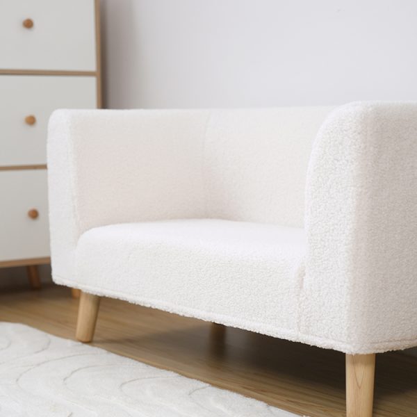 Cream 2-seater kids sofa with bouclé upholstery in a modern children's room