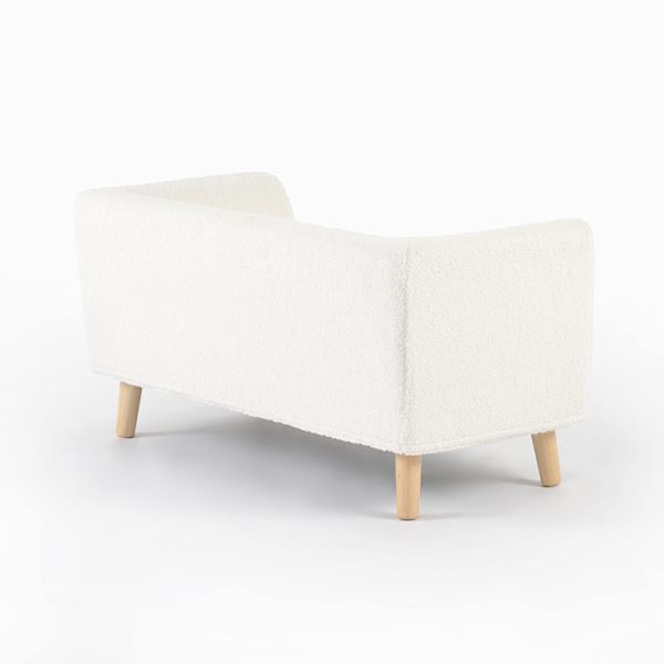 Side view of upholstered bouclé kids sofa with wooden legs for children's rooms
